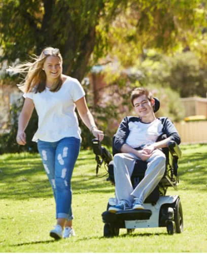 Women and a Disabled Man on Wheel Chair Walking